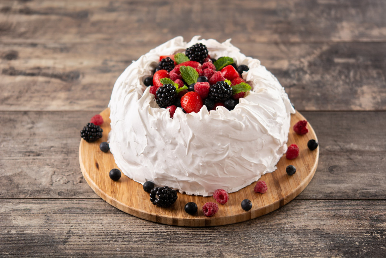 delicious pavlova cake with meringue topped fresh berries