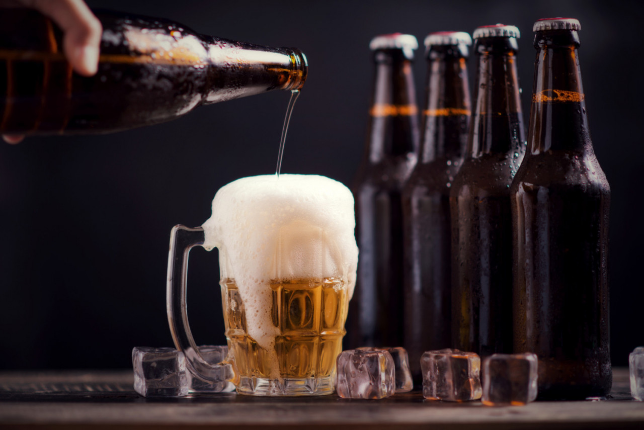 glass bottles beer with glass ice dark background