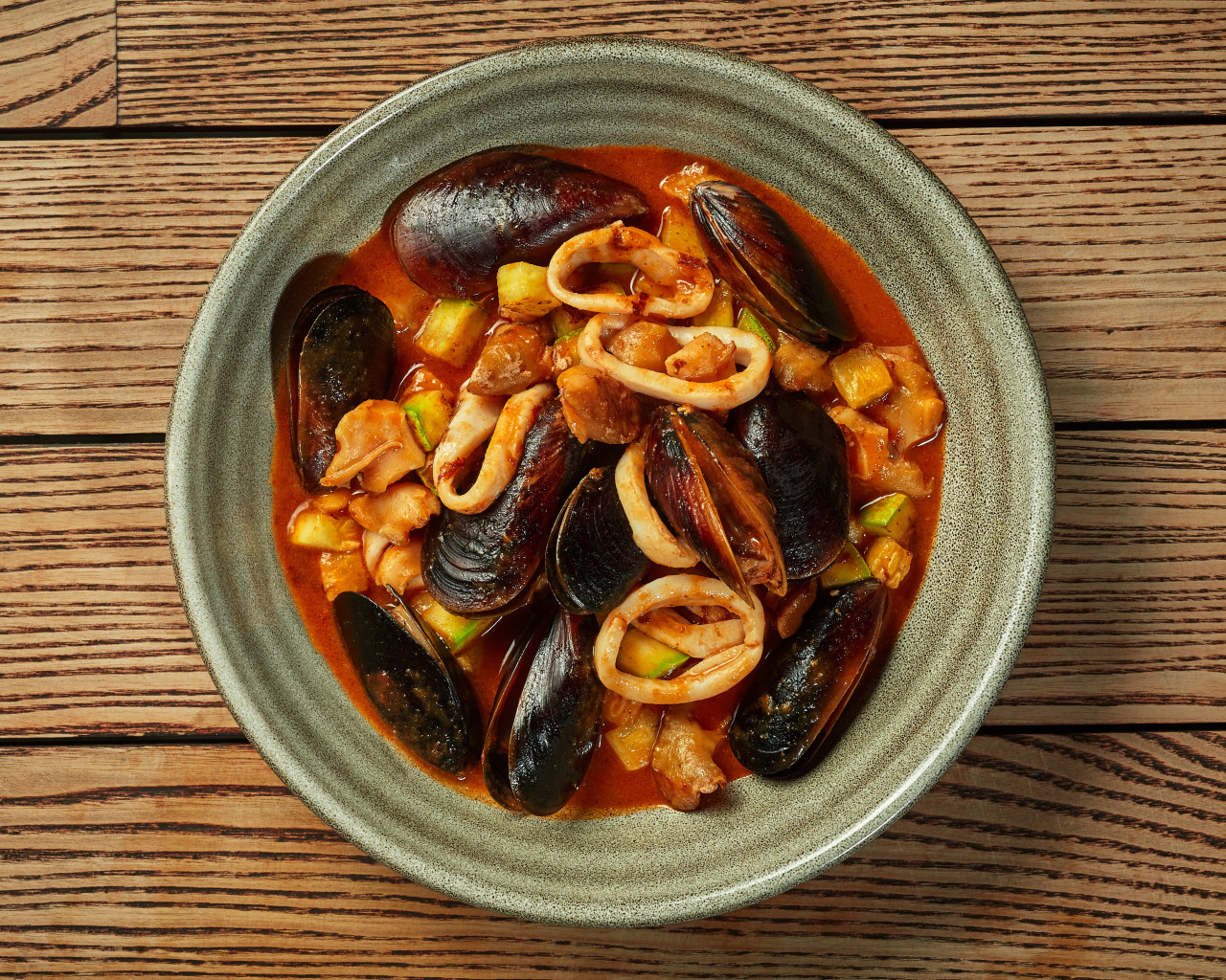 seafood stew with fish mussels squid whelks vegetables