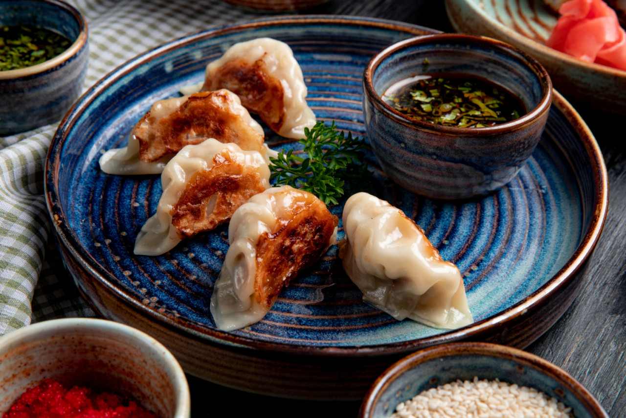 side view traditional asian dumplings with meat vegetables served with soy sauce plate rustic