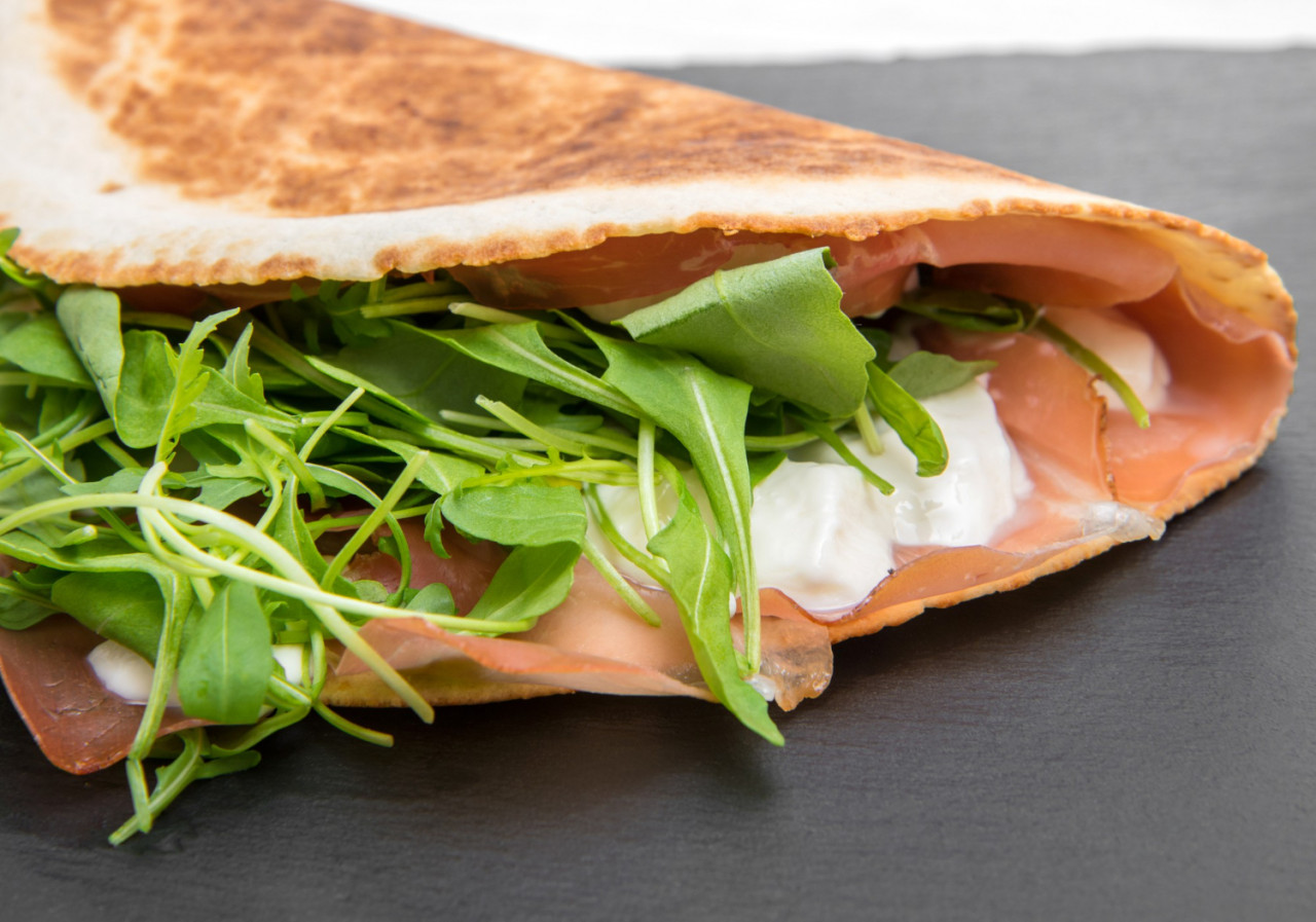 typical piadina romagnola with ham cheese rocket