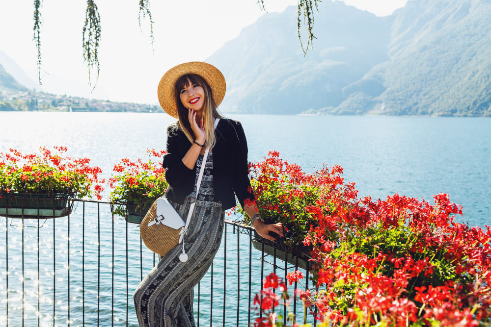 young elegant woman straw hat balcony with flowers lake como