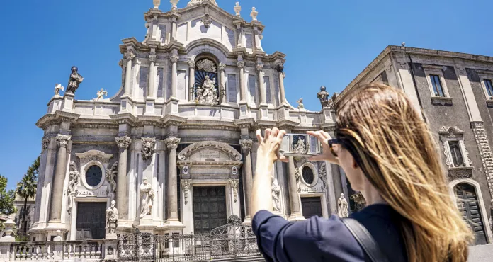 Catania Sicily Piazza Del Duomo With Duomo Saint Agatha Woman Tourist Takes Picture With Smartphone Summer Sunny Day