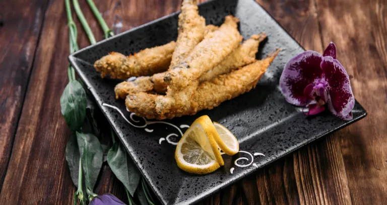 Closeup Deep Fried Capelin With Slices Lemon