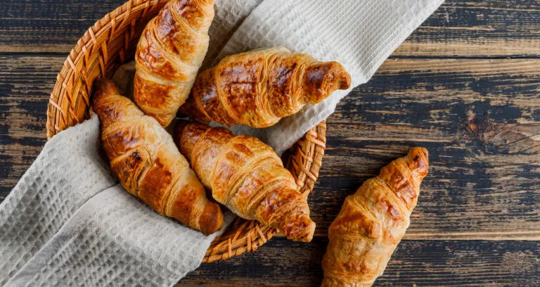 Croissant Basket With Cloth Wooden Table Flat Lay