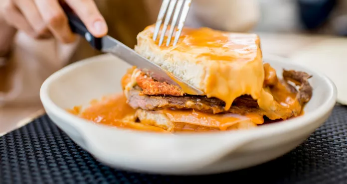 Eating Traditional Portuguese Meat Sandwich With Tomato Sauce Called Francesinha Restaurant Porto City
