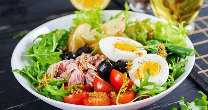 Healthy Hearty Salad Tuna Green Beans Tomatoes Eggs Potatoes Black Olives Close Up Bowl Table
