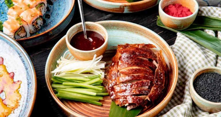 Side View Traditional Asian Food Peking Duck With Cucumbers Sauce Plate