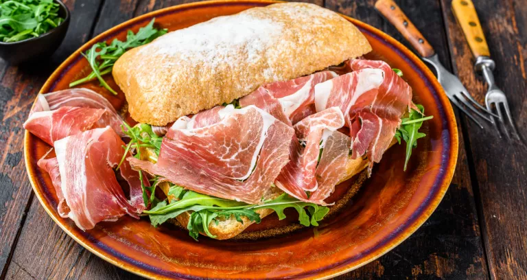 Spanish Bocadillo De Jamon Serrano Ham Sandwich Ciabatta Bread With Arugula Dark Wooden Background Top View