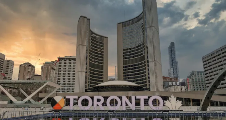 Toronto Signage Near Buildings Under White Clouds 1