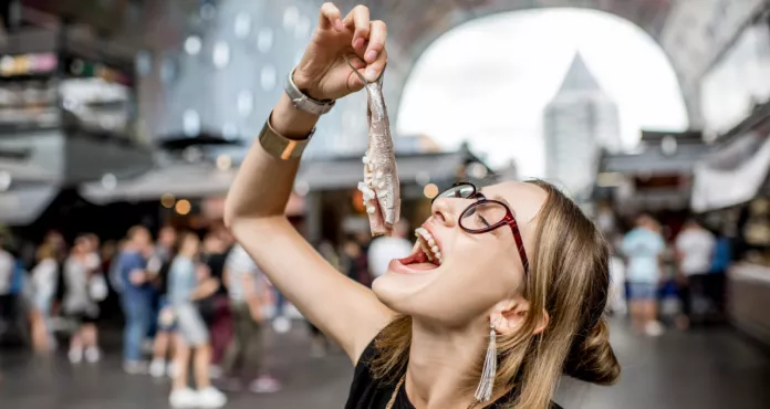 Young Woman Eating Herring With Onions Traditional Dutch Snack Rotterdam Market