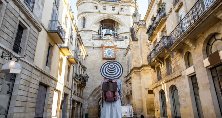 Young Woman Tourist With Big Hat Standing Back Front Famous Bell Tower Bordeaux City France