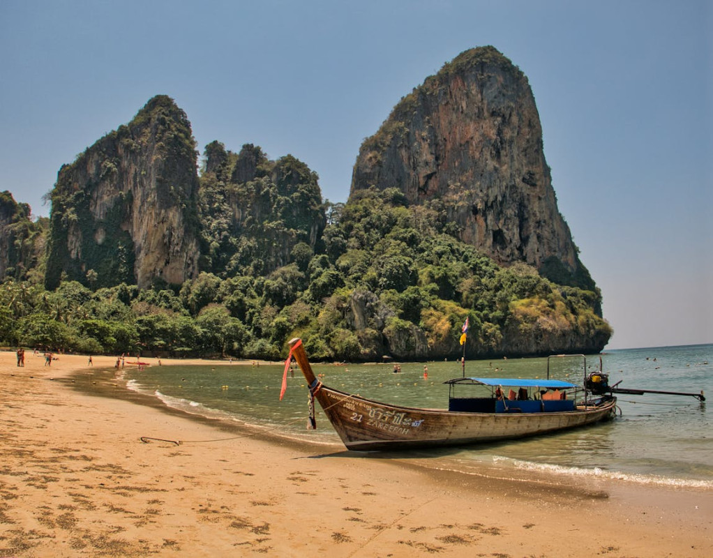 a boat docked on the railay beach 1