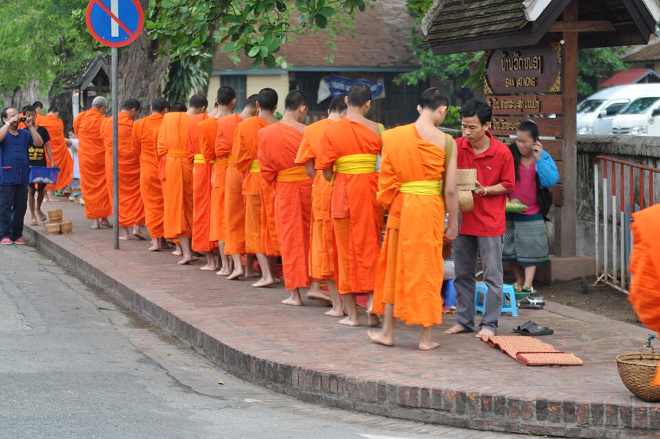 a man gives to the last monk in the line 14603806974
