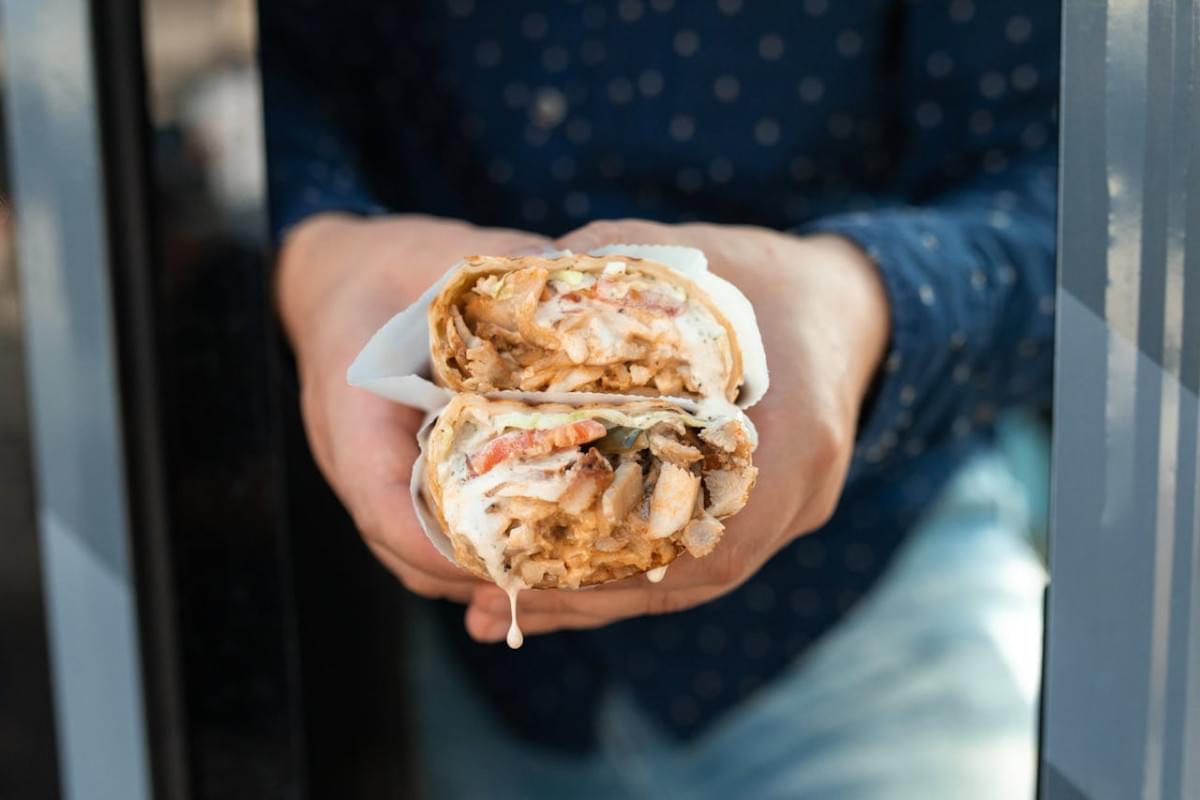 a person holding a shawarma 1