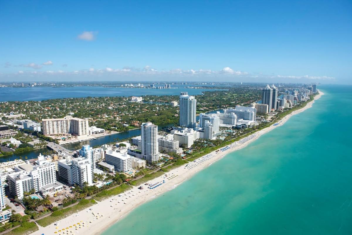 aerial view of city buildings near body of water