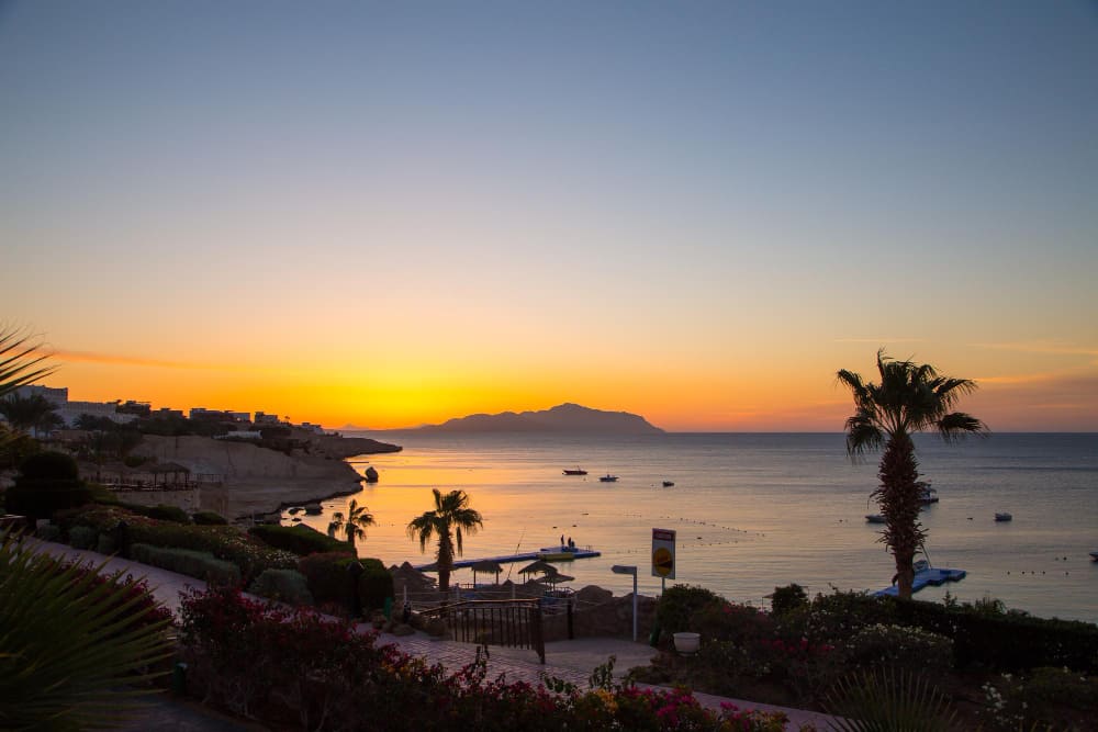 alba sul mar rosso bel cielo luminoso con raggi di sole e nuvole mattutine mare e barche vista dell isola di tiran egitto sharm el sheikh turismo e viaggi