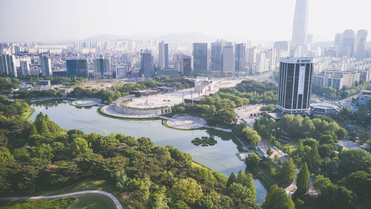 an aerial photography of olympic park near the body of water