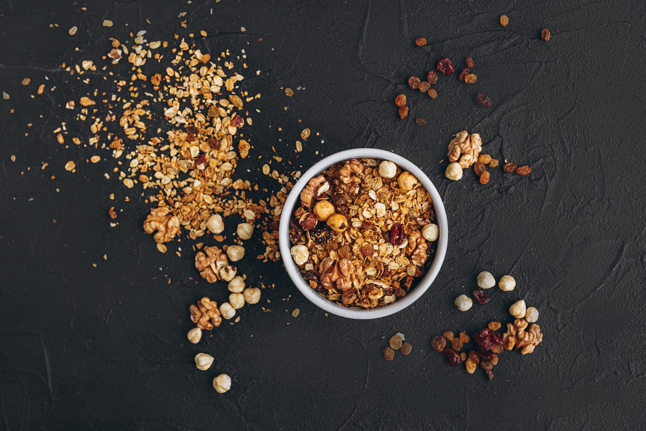 atmeal granola with honey nuts dried fruits grains is poured out package into plate