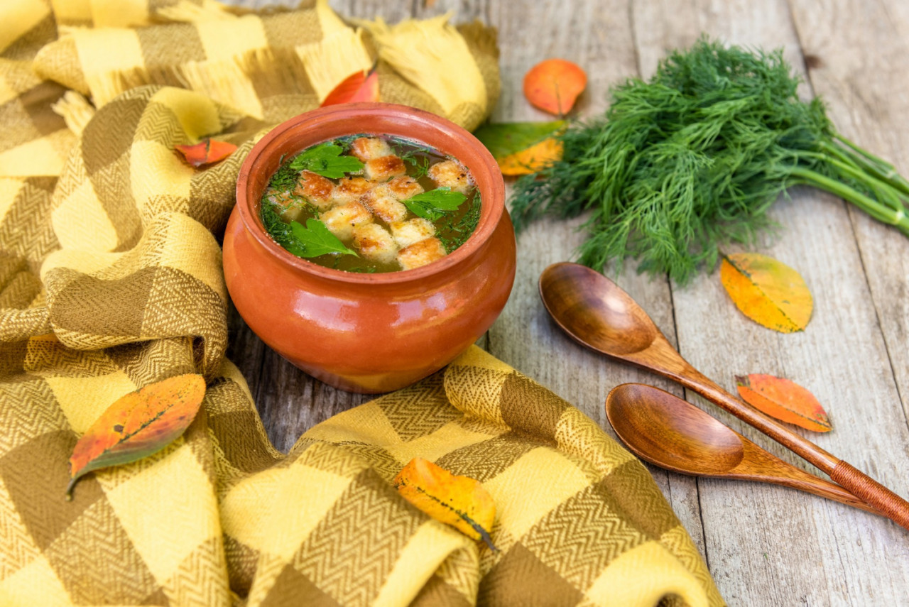 autumn soup with croutons herbs clay pots