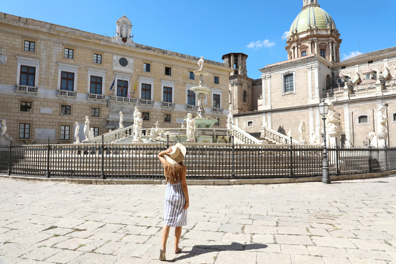 back view young beautiful woman walking near monumental praetorian fountain palermo italy