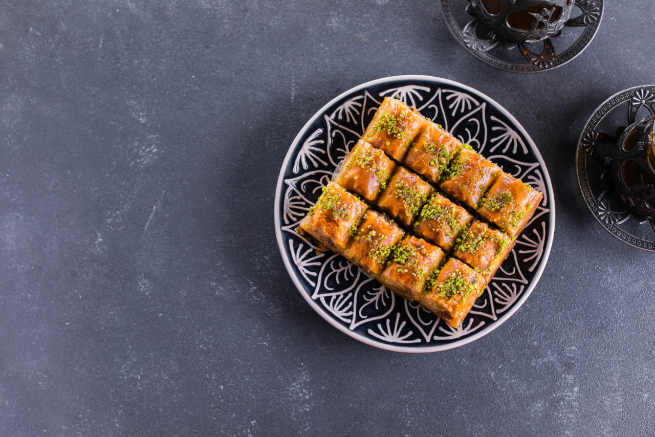 baklava ramadan dessert traditional arabic dessert with nuts honey cup tea concrete table top view copy space