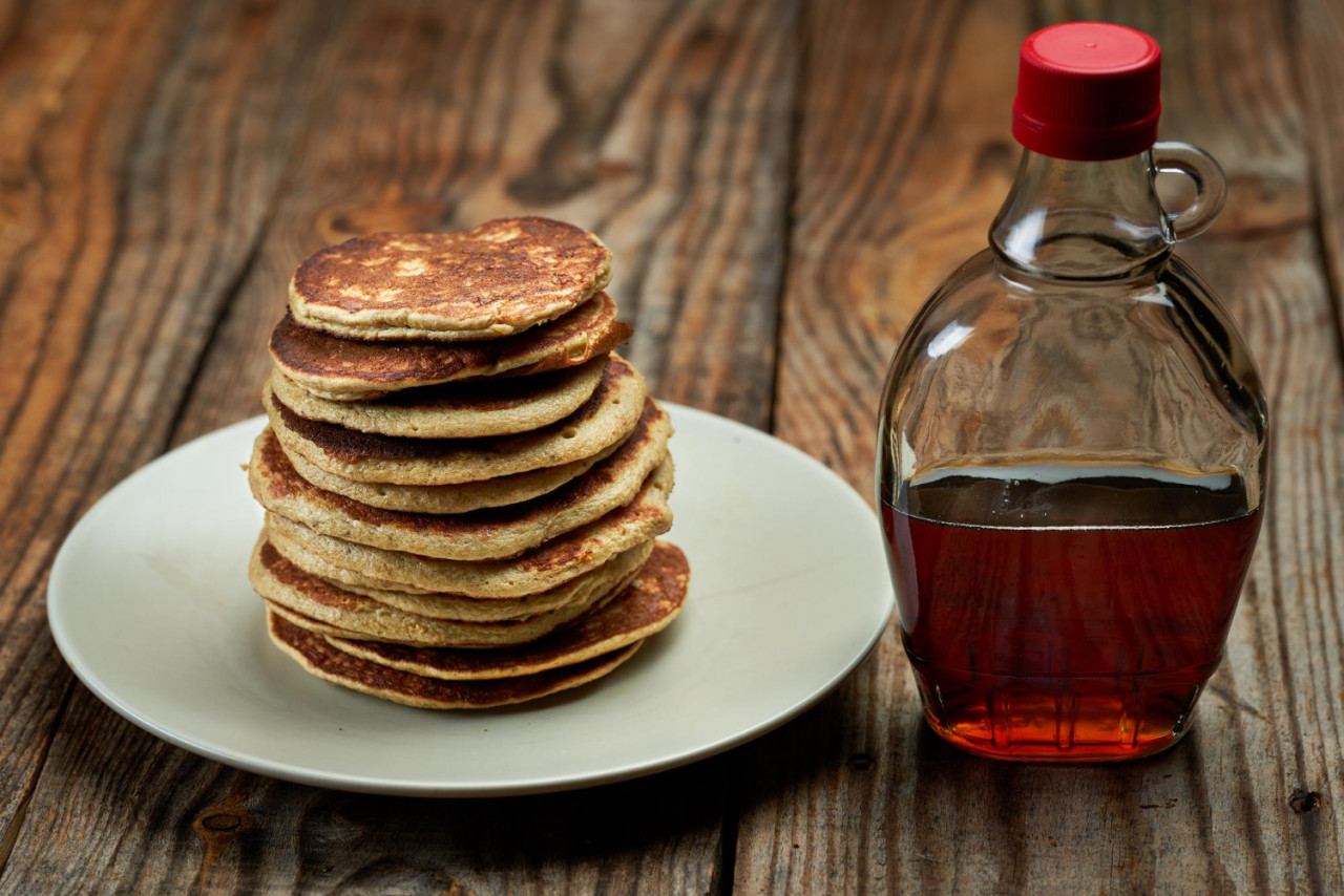 banana oat protein pancakes with maple syrup wooden board