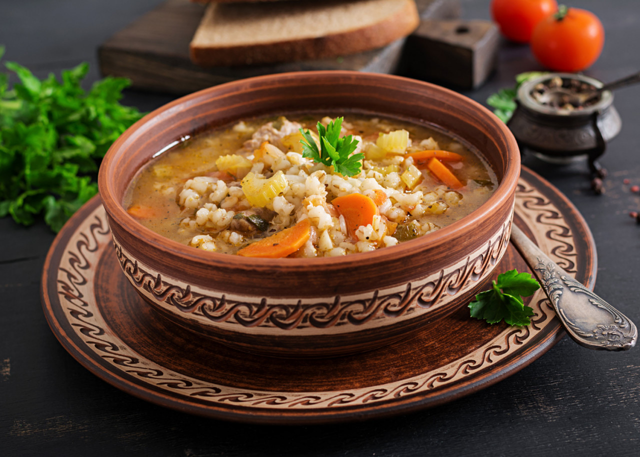 barley soup with carrots tomato celery meat dark surface