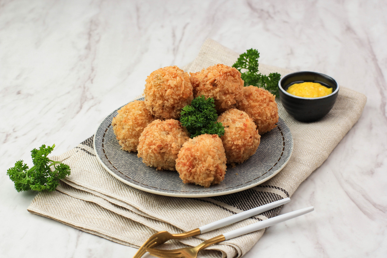 bitterballen is dutch snack made from round shaped dough filled with mozzarella cheese served with mustard