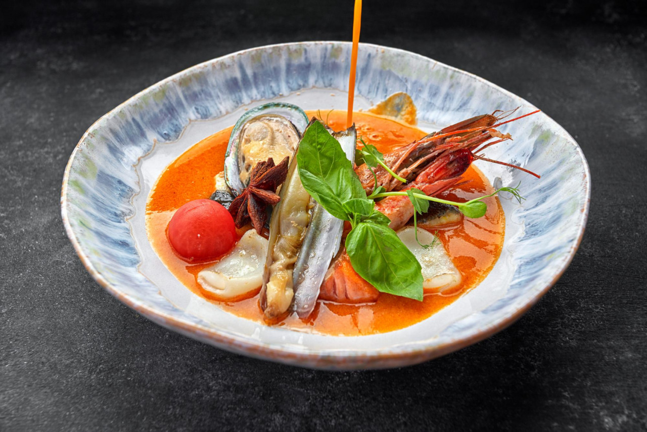 bouillabaisse soup with seafood mussels shrimp squid plate dark background