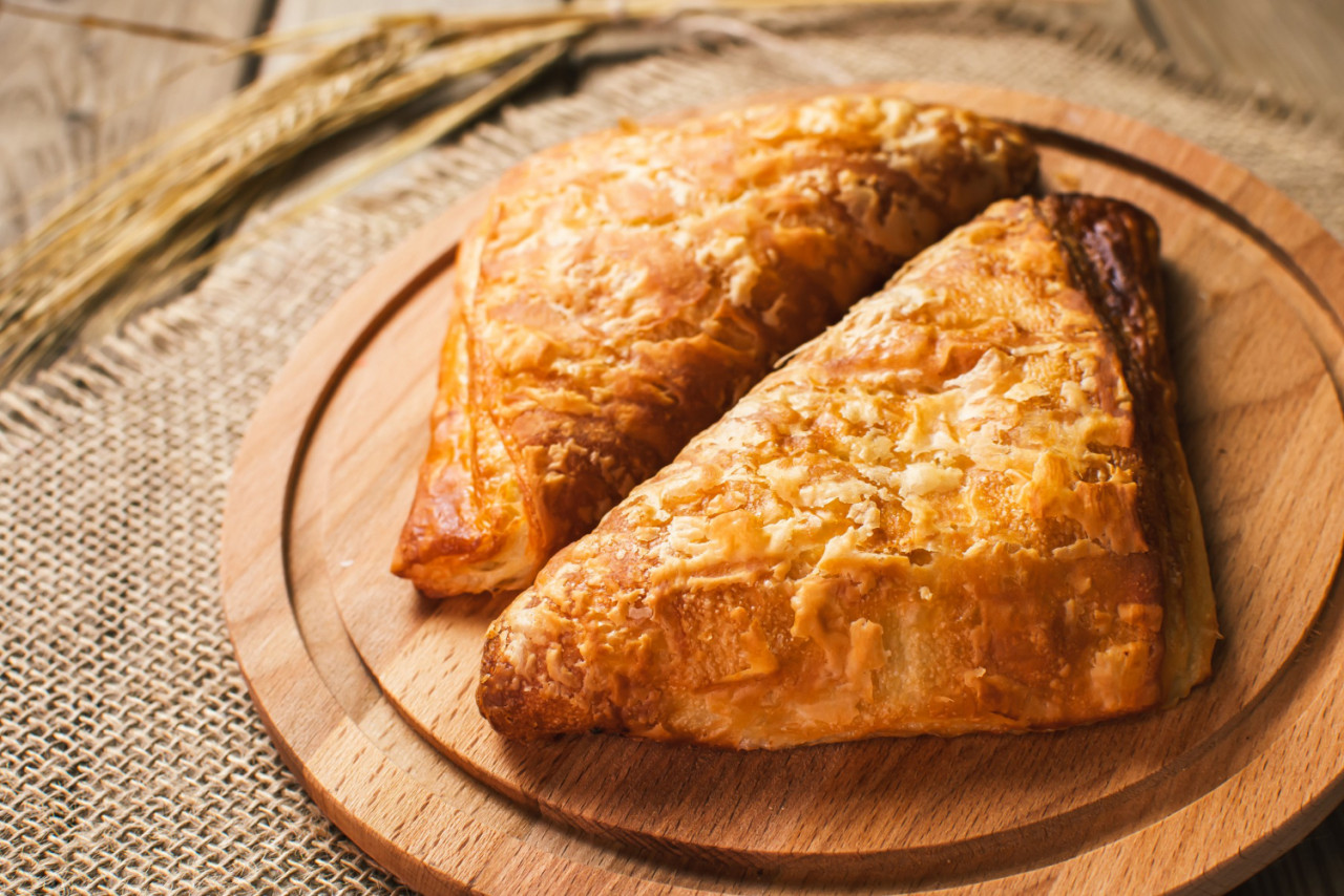 burekas filled with cheese wooden table cutting board freshly baked