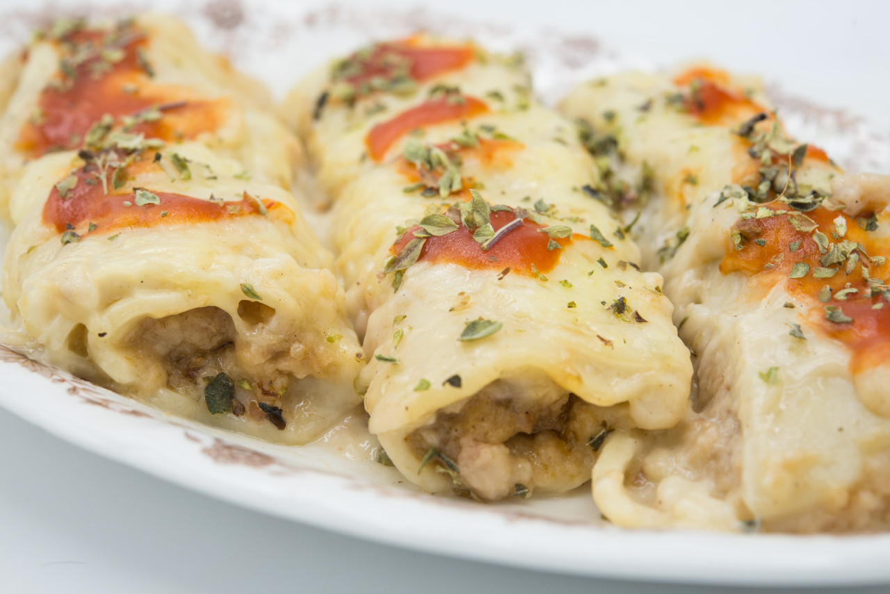 canelones cannelloni with meat filled pasta cheese tomato plate