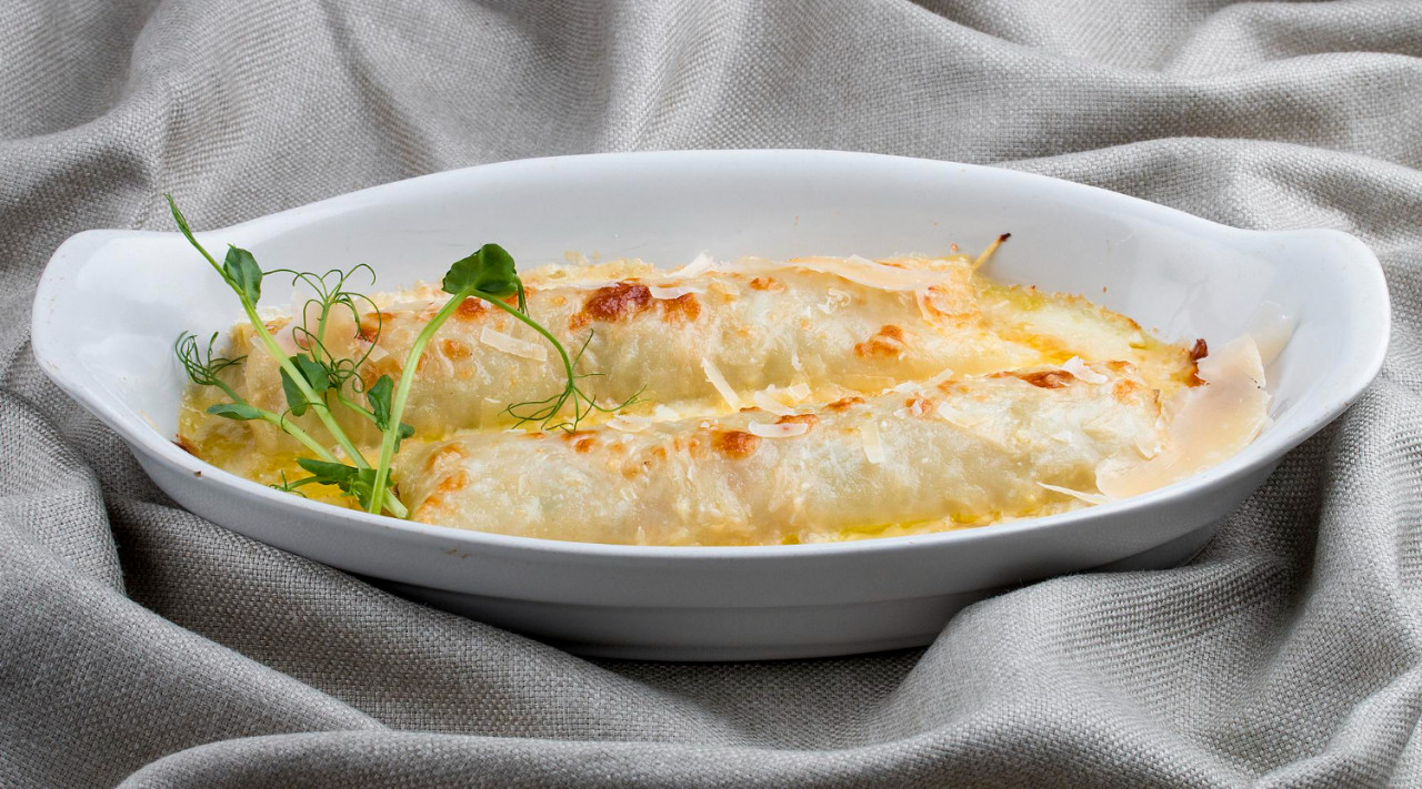 cannelloni with minced meat baked white ceramic plate textile background