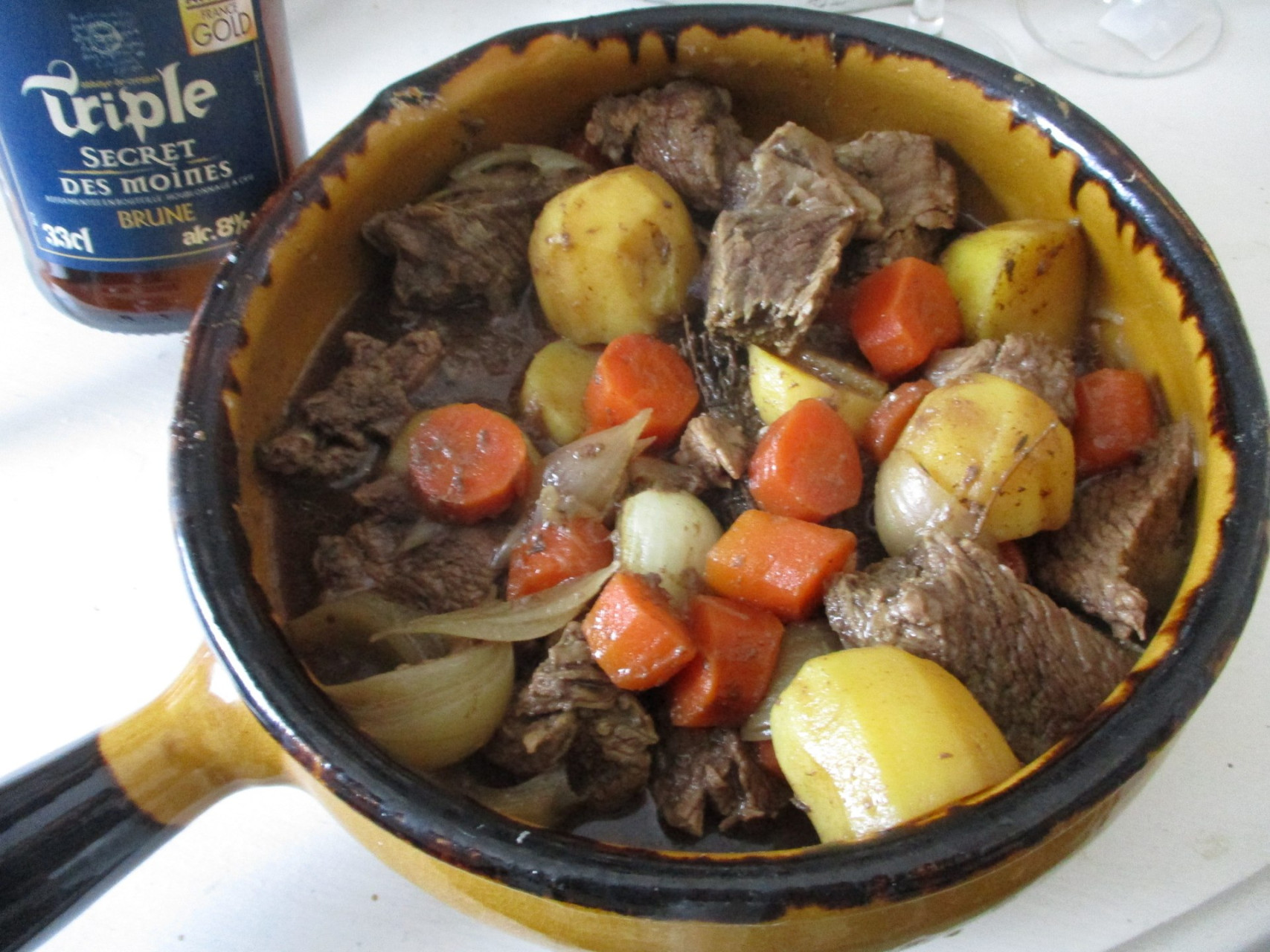 Spezzatino di carne cotto nella birra scura servito con patatine fritte.