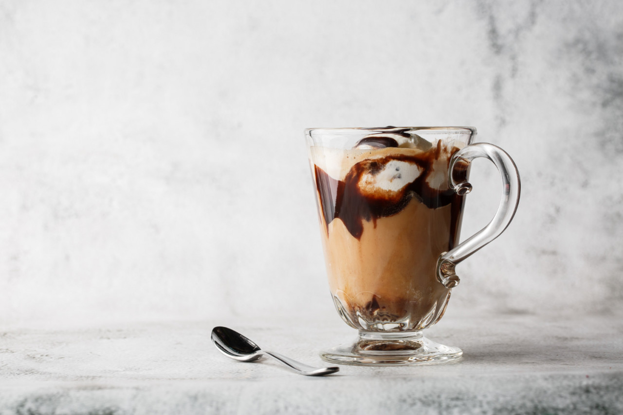 chocolate frappe with whipped cream chocolate syrup ice cream bright marble background overhead view copy space advertising cafe menu coffee shop menu horizontal photo