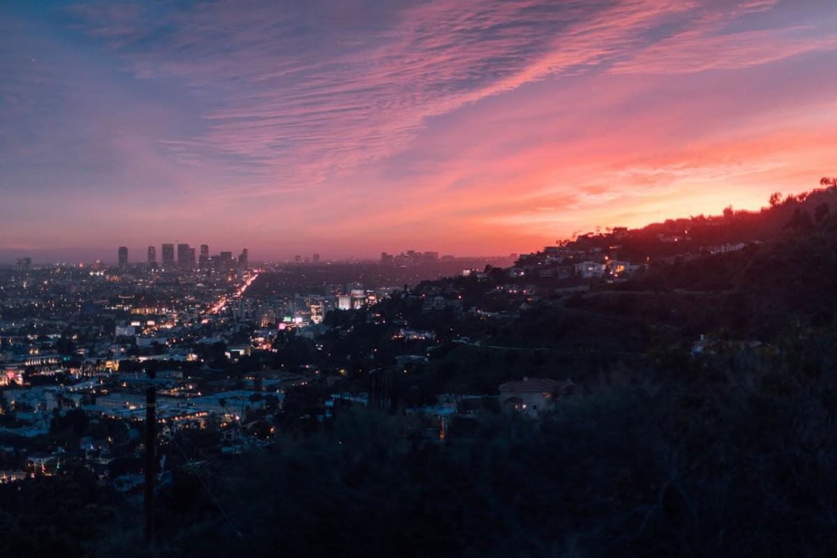 city near mountain during golden hour 1