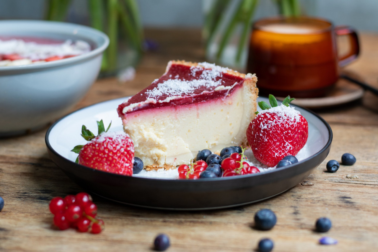 closeup shot cheesecake with jelly decorated with strawberries berries