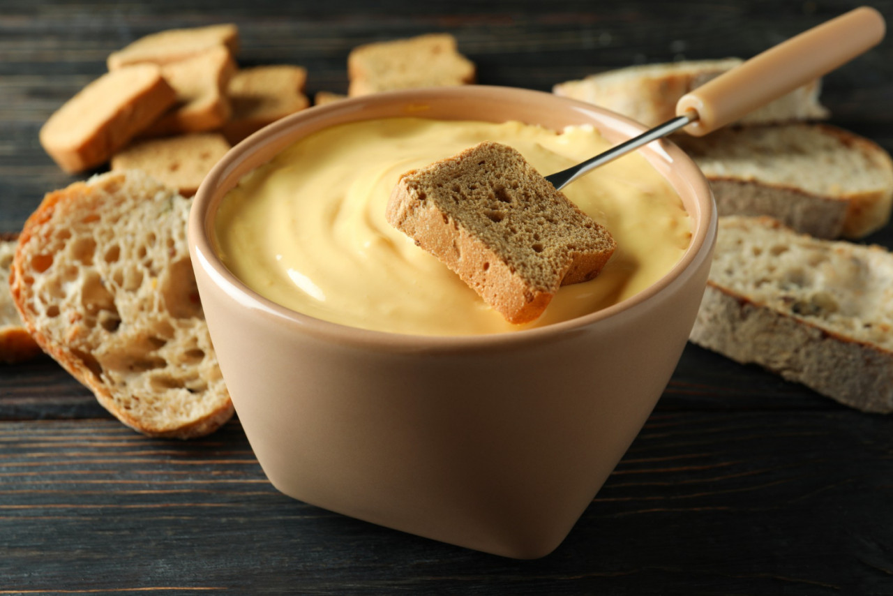 concept delicious food with fondue wooden table