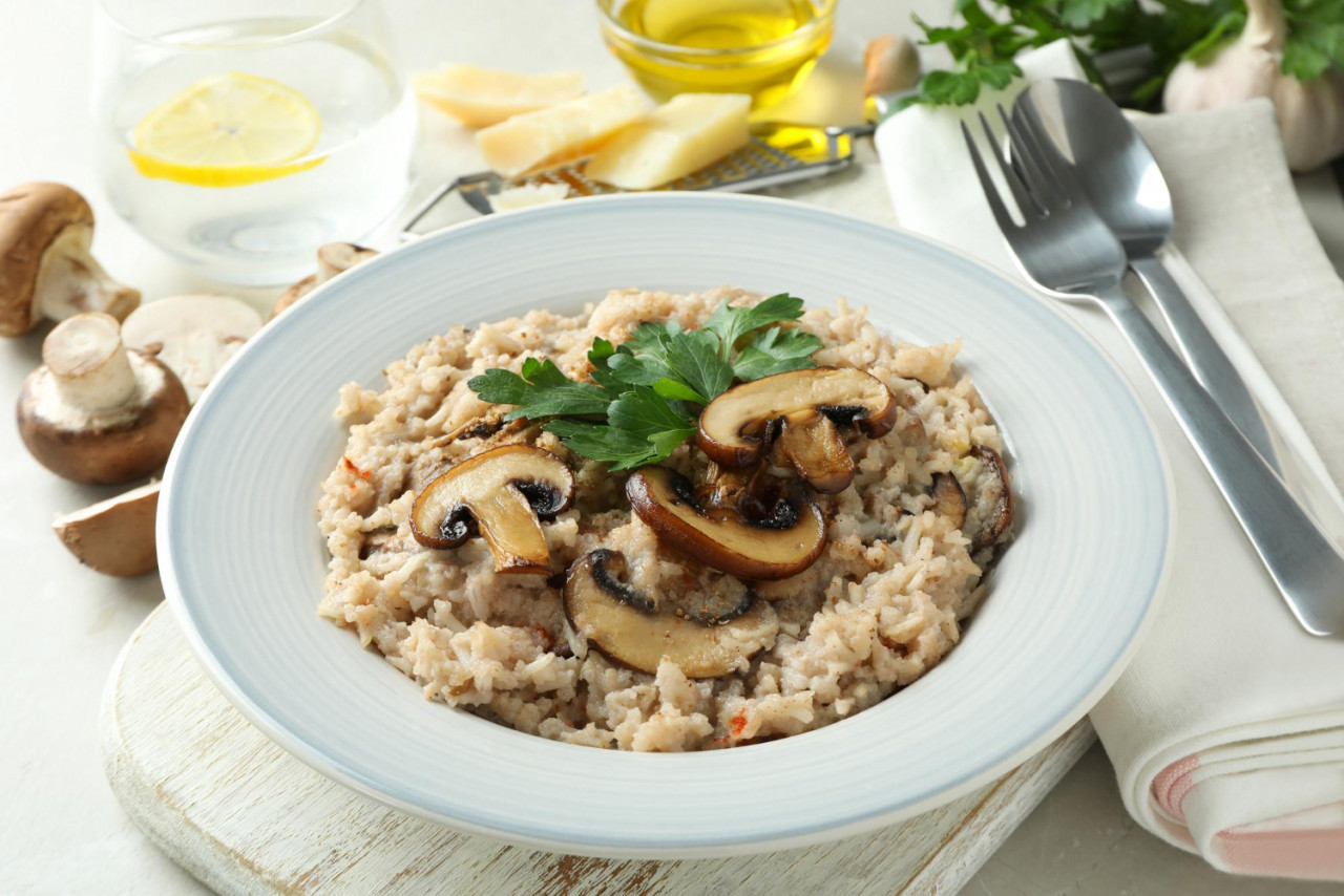 concept tasty food with risotto with mushrooms close up