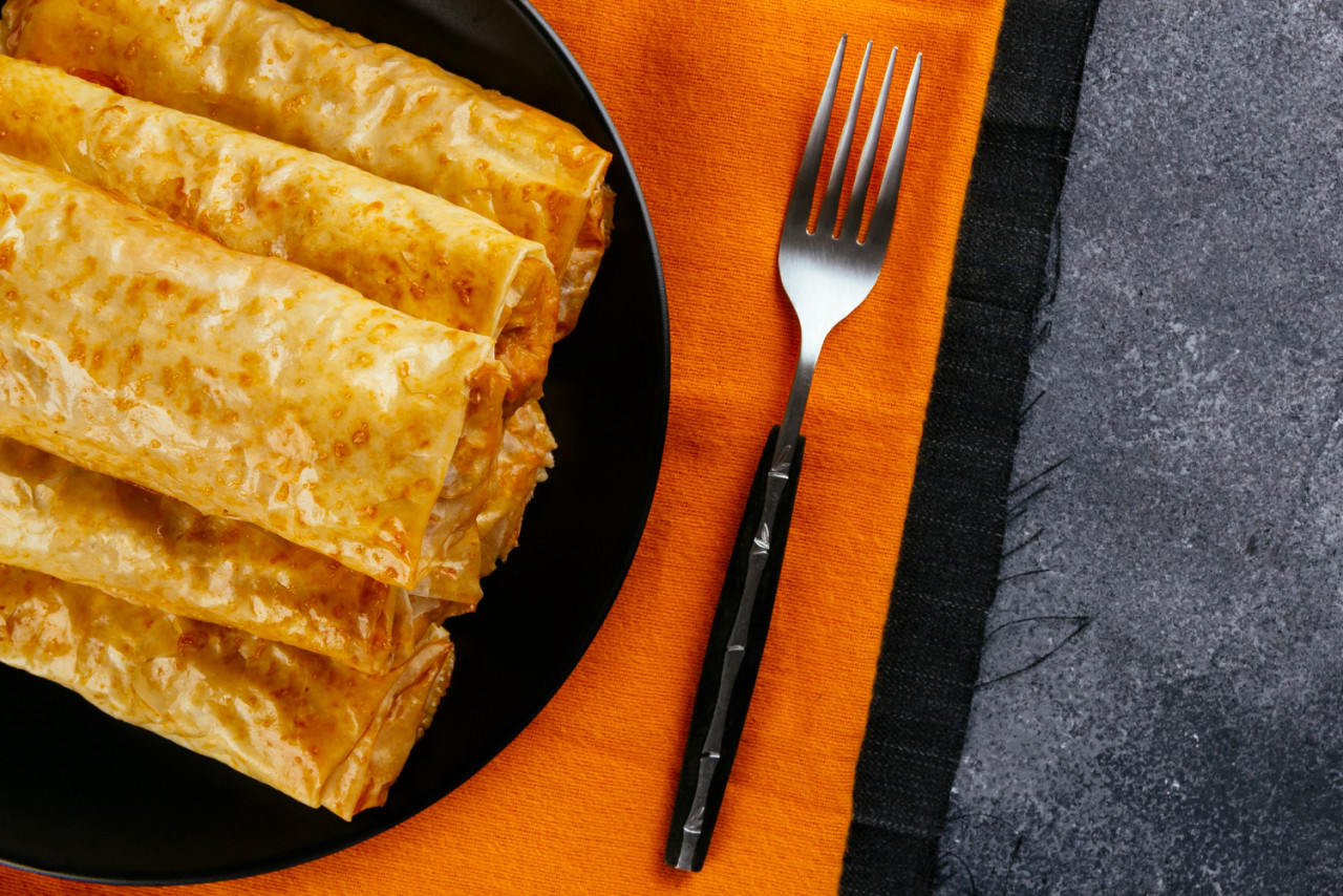 crispy phyllo dough rolls freshly baked served black plate