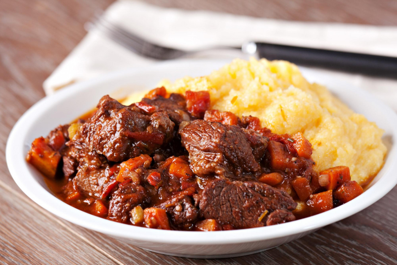 delicious beef stew with mushrooms polenta high quality photo