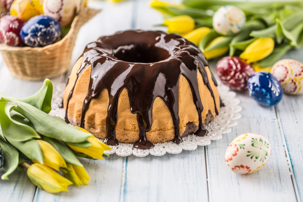 delicious holiday slovak and czech cake babovka with chocolate glaze easter decorations spring tulips and eggs