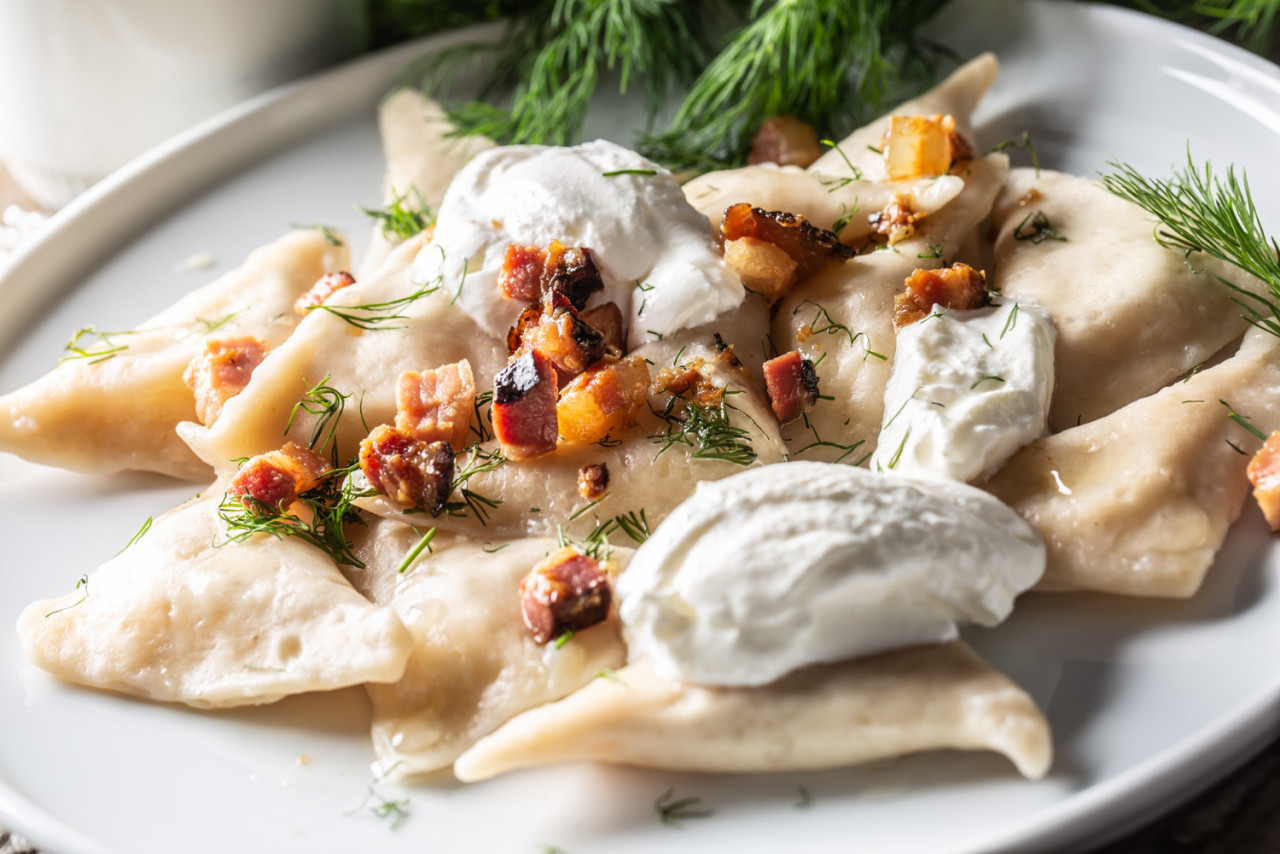 Filled Pirohy Dish Served With Fried Bacon Fresh Dill And Sour Cream