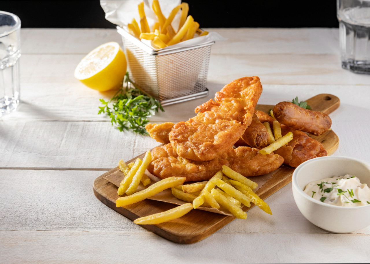 fish chips chopping board with lemon sauce