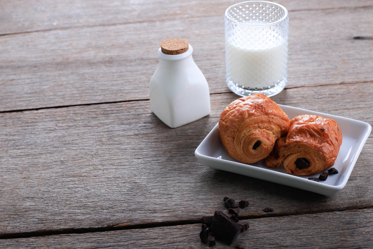 fresh baked chocolate croissants pain au chocolat with milk breakfast served white plate rustic table copy space text