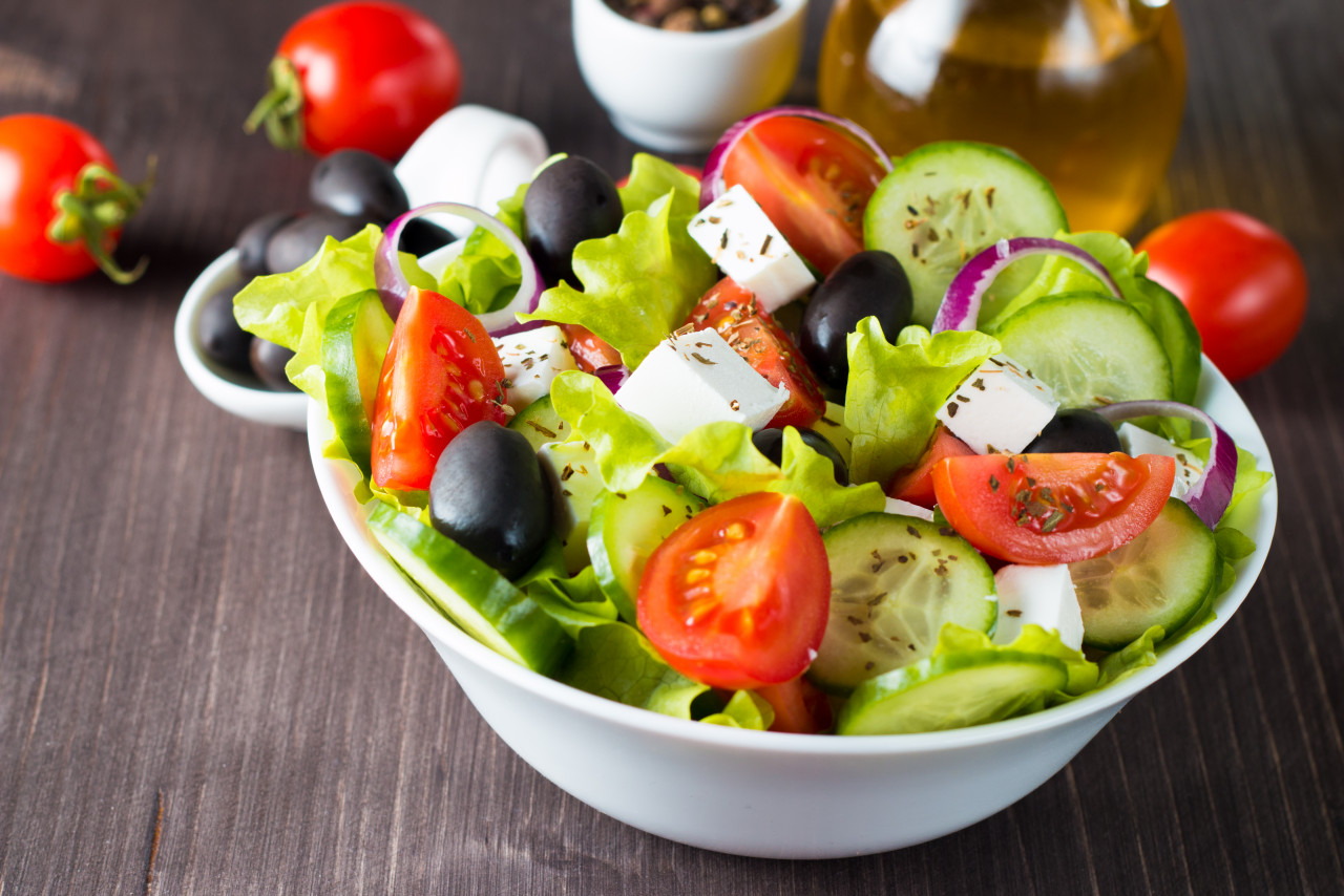 fresh greek salad wooden background