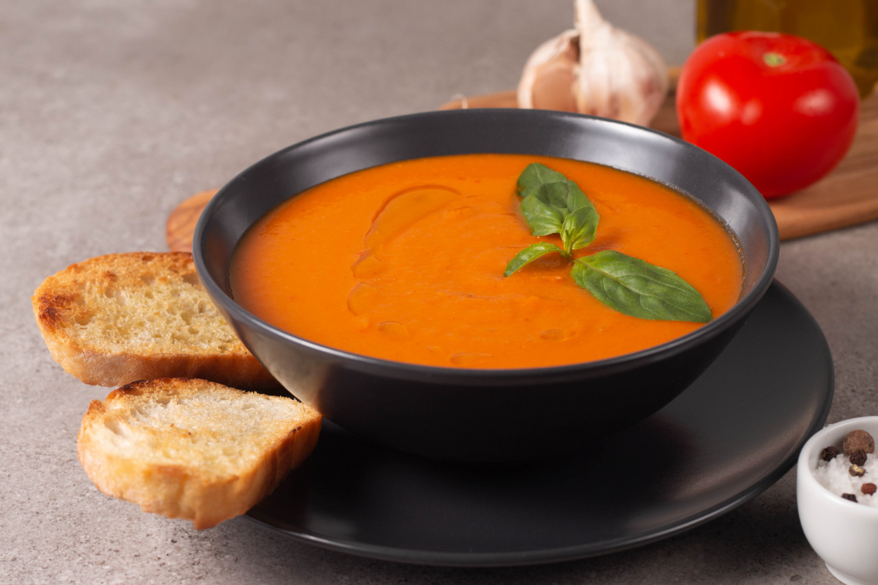 fresh healthy tomato soup with basil pepper garlic tomatoes bread wooden background