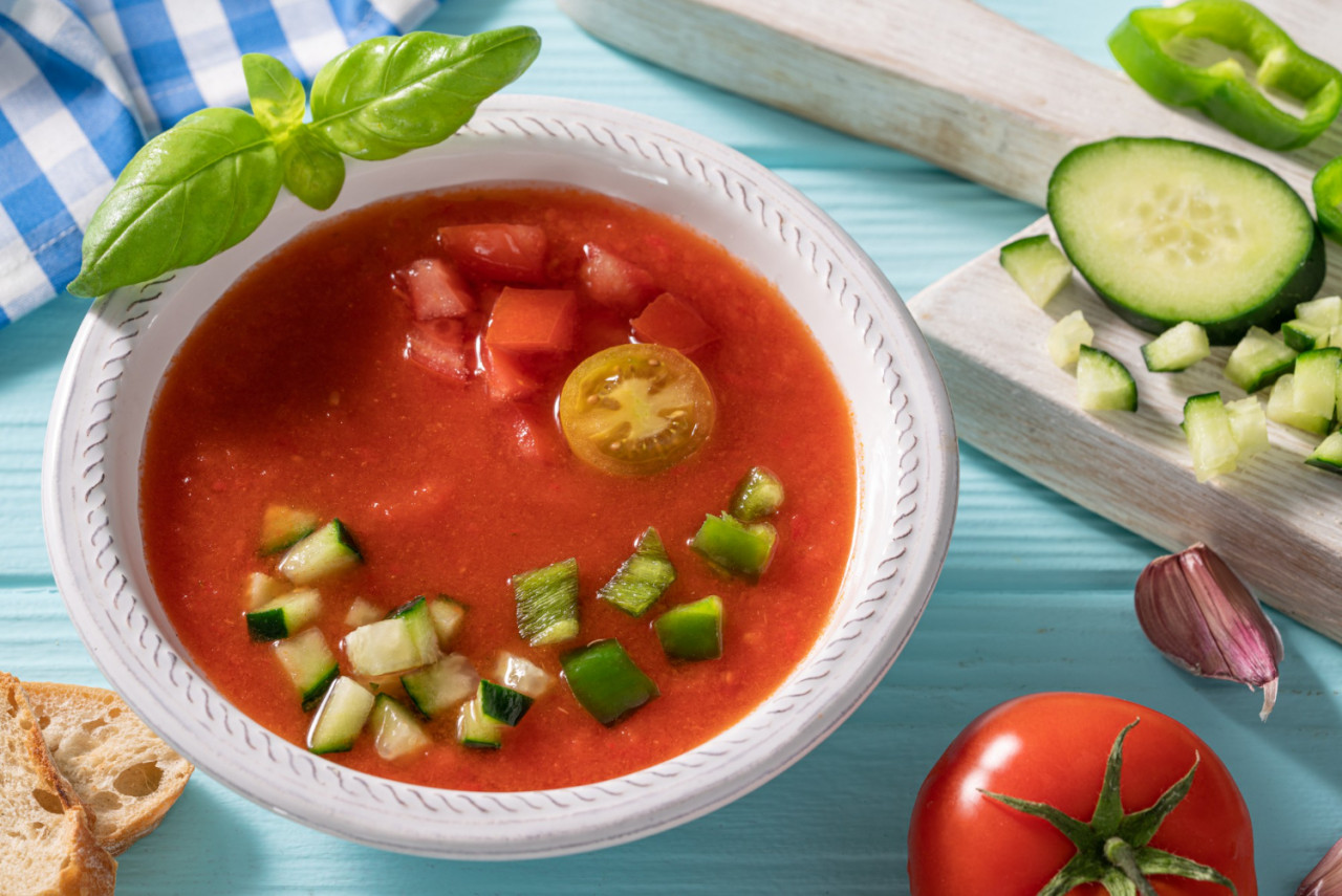 gazpacho andaluz is andalusian tomato cold soup from spain with cucumber garlic pepper light blue table