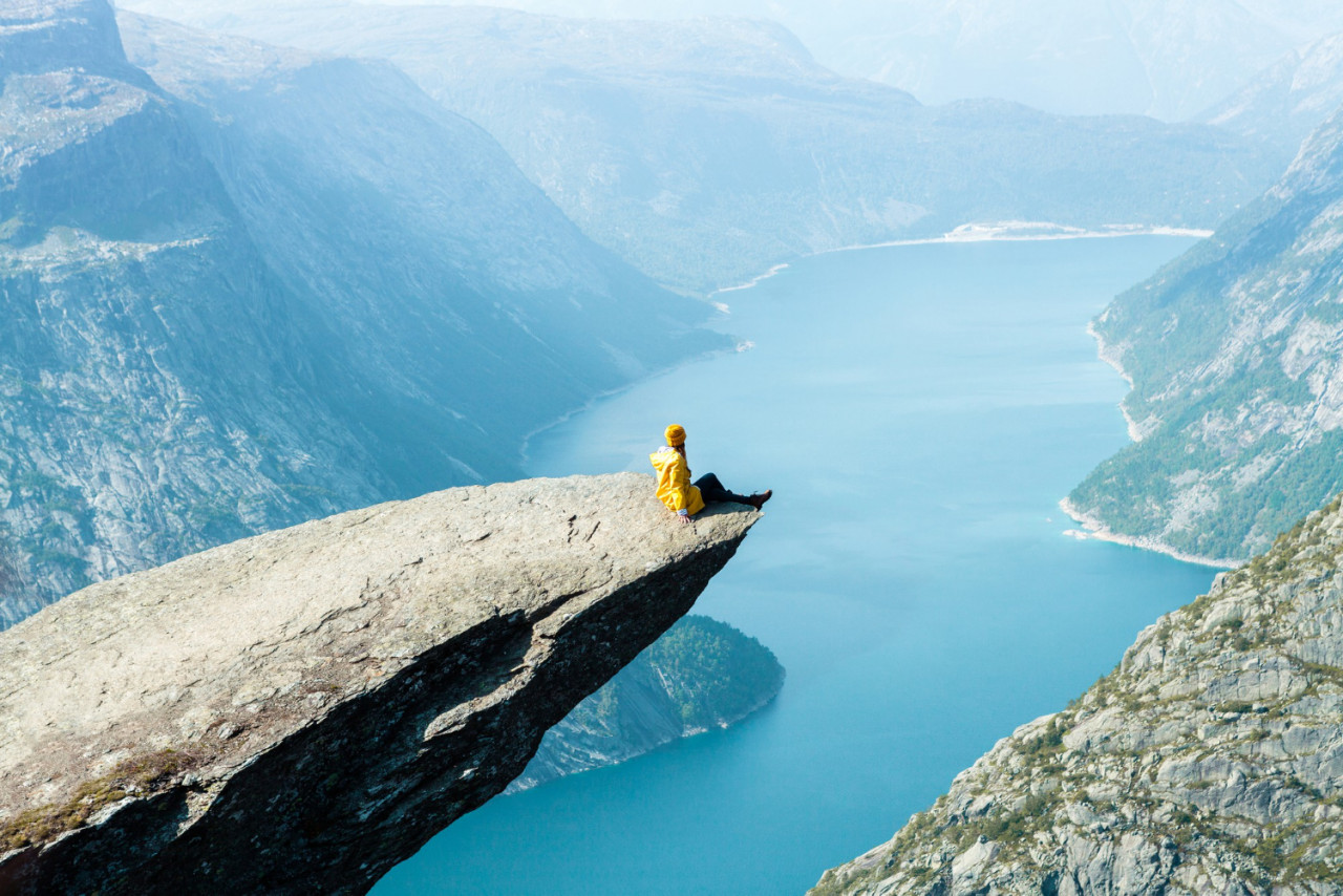 girl yellow jacket seats trolltunga norway