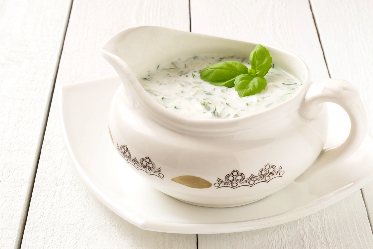 greek tzatziki sauce with yogurt cucumbers garlic dill white wooden table